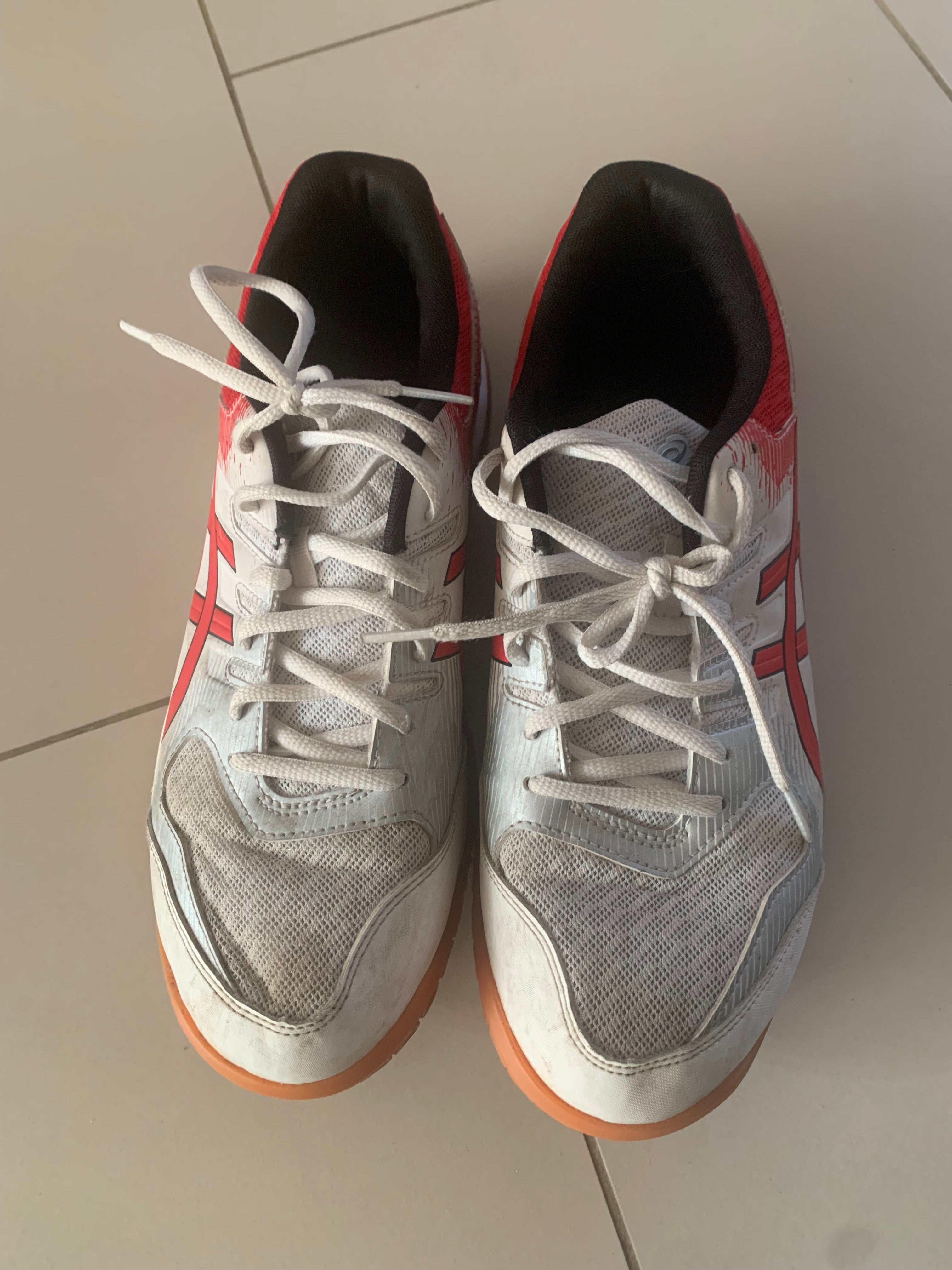 These are Asics Gel-Rocket 9 indoor court shoes in white and classic red.